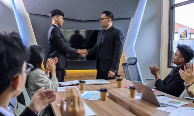 Excited worker getting promotion, recognition, respect and applause of colleagues.