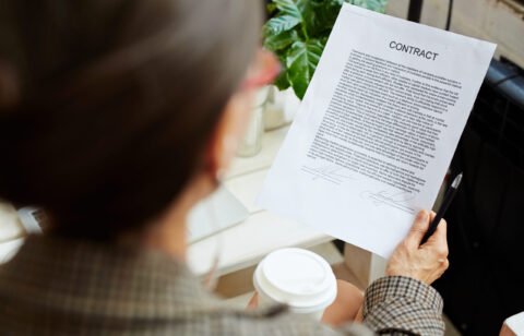 Business contract held and read by businesswoman